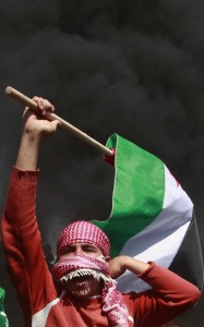 palestinian-protester-holds-flag-during-protest-marking-land-day-near-border-between-israel